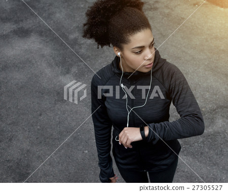 Young sporty woman with fitness tracker  27305527