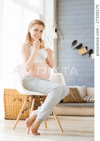 Pregnant woman having healthy breakfast Pregnant woman having healthy breakfast 27309270