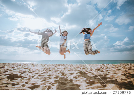 happy women jumping on the beach. happy women jumping on the beach. 27309776