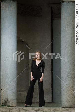 Red hair fashion model in black overall posing 27309931