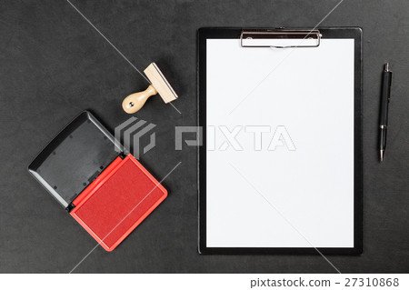 Black clipboard on a table 27310868