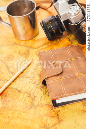 notebook, camera on the background of vintage map notebook, camera on the background of vintage map 27311288