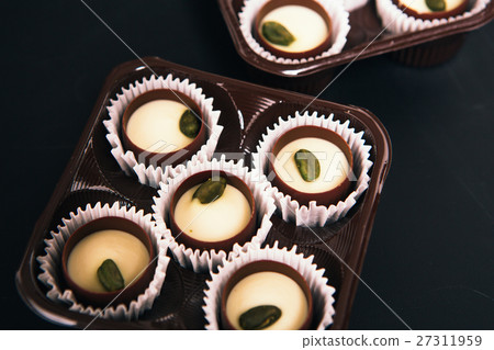 Many chocolate sweets Pistachio black background Many chocolate sweets Pistachio black background 27311959