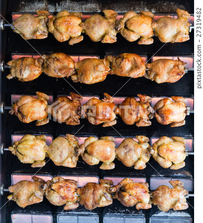 Juicy chicken grilled on rolling spit in store Juicy chicken grilled on rolling spit in store 27319482