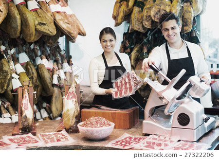 Portrait of sellers offering tasty jamon Portrait of sellers offering tasty jamon 27322206