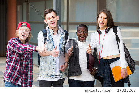 Positive four friends with folders and backpacks Positive four friends with folders and backpacks 27322208