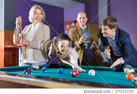 Group of cheerful pretty positive friends playing billiards Group of cheerful pretty positive friends playing billiards 27322210