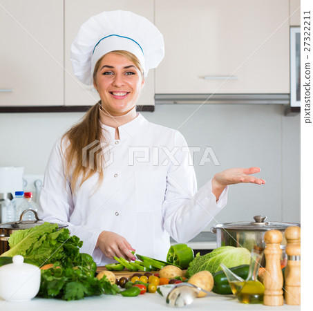 Professional chef with vegetables at kitchen table Professional chef with vegetables at kitchen table 27322211