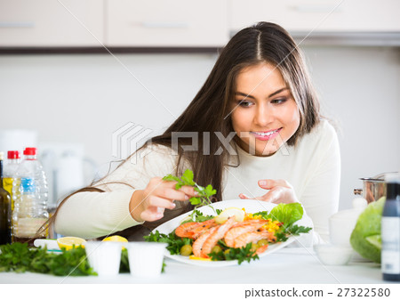 Woman decorating fried prawns Woman decorating fried prawns 27322580