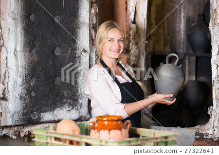 Portrait of woman with black glaze pot 27322641