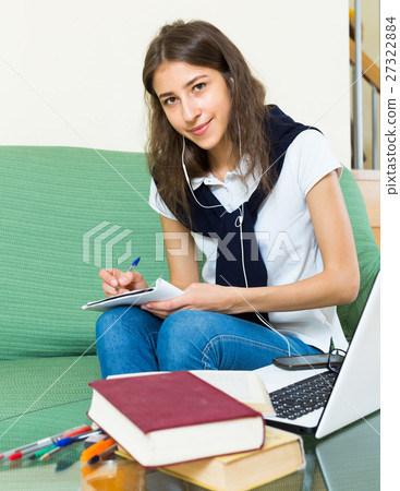 young girl using laptop at home young girl using laptop at home 27322884