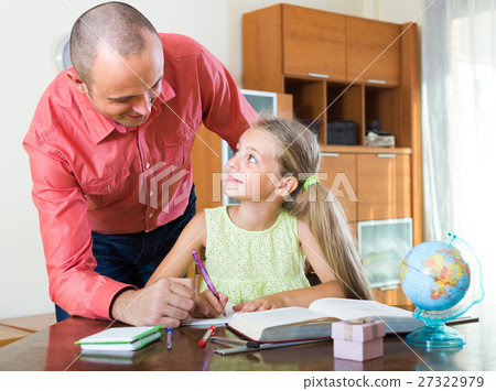 Man and little girl with books indoors. 27322979