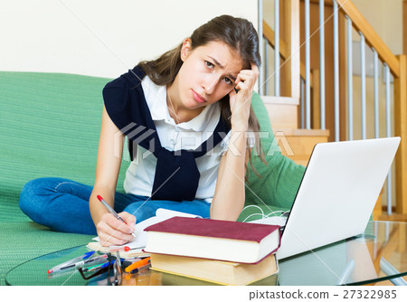 Unhappy girl study at home 27322985
