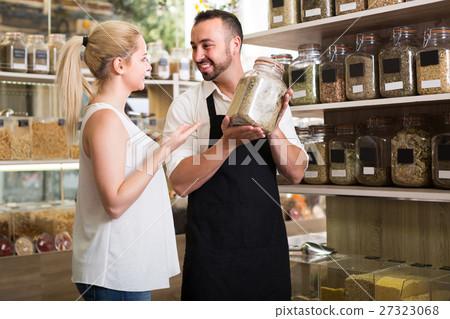 man selling herbs and spices in organic store. 27323068