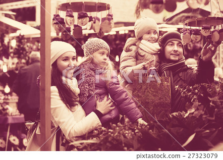 Family with children purchasing toys Family with children purchasing toys 27323079