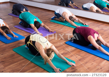 People relaxing and enjoying yoga People relaxing and enjoying yoga 27323120