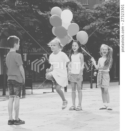 children with chinese jumping rope . 27323301
