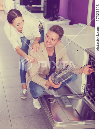 Family selecting modern dishwasher 27323398