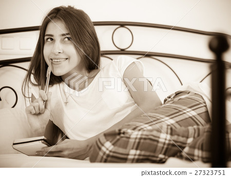 Portrait of girl putting dreams in notepad 27323751