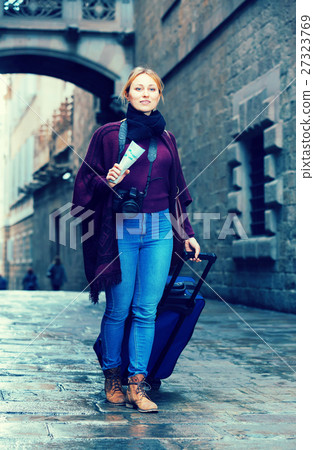 Tourist girl walking with the travel bag. Tourist girl walking with the travel bag. 27323769