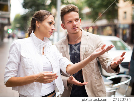 Woman showing direction to guy 27323784