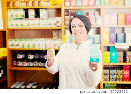 Woman in white coat promoting food additive goods in carton in d Woman in white coat promoting food additive goods in carton in d 27323812