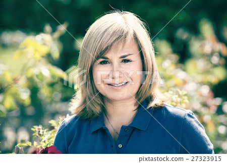 Portrait of mature woman standing in garden 27323915