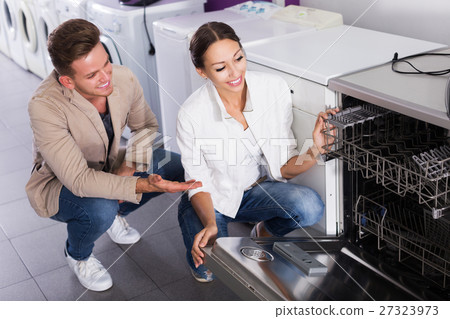 Family selecting modern dishwasher Family selecting modern dishwasher 27323973