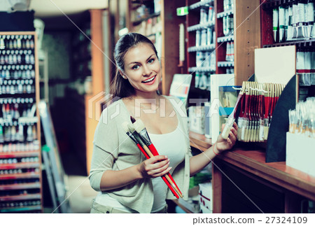 Portrait of cheerful woman choosing brushes for drawing Portrait of cheerful woman choosing brushes for drawing 27324109