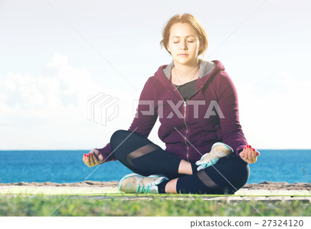 girl exercising on exercise mat outdoor 27324120