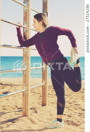 Sporty woman exercising at sea beach Sporty woman exercising at sea beach 27324286