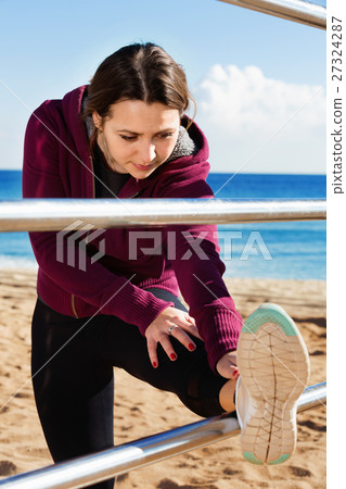 Sporty woman exercising at sea beach 27324287