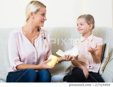 Mother with daughter discussing menstruation and sanitary products 27324404