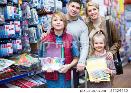 Parents and children choosing writing materials 27324480
