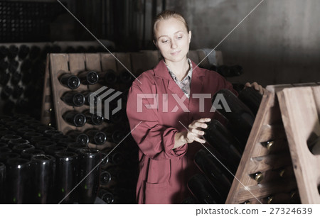 Laughing woman winery employee working in cellar Laughing woman winery employee working in cellar 27324639