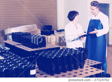 Employees checking number of wine bottles 27324702