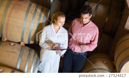 client and factory staff in wine cellar. 27324817