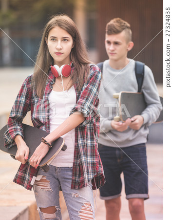 Teenagers with skateboards walking 27324838