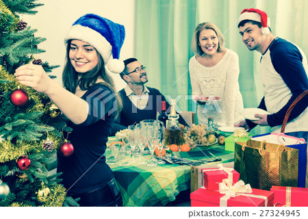 Cheerful family setting table for dinner 27324945