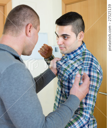 Two adult males fighting indoor Two adult males fighting indoor 27325139