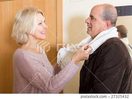 Senior woman setting scarf on man Senior woman setting scarf on man 27325432