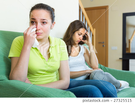 Two young women after quarrel at home. Two young women after quarrel at home. 27325515