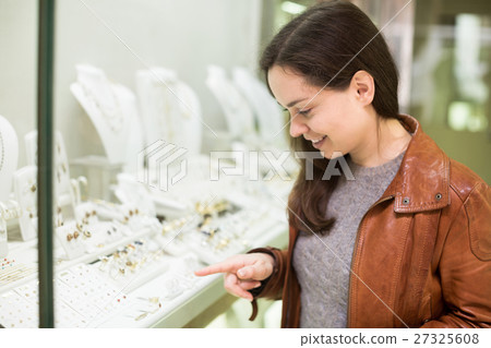 Woman customer admiring jewellery 27325608