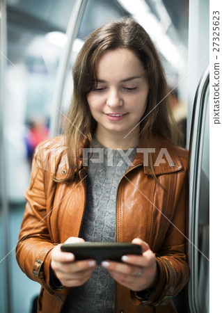 Woman with smartphone at subway 27325623