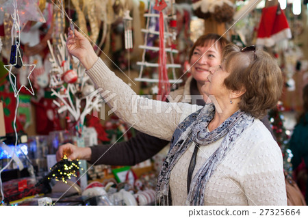 female pensioners buying X-mas decorations at fair female pensioners buying X-mas decorations at fair 27325664