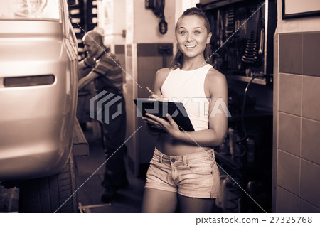 Adult smiling working woman holding cardboard Adult smiling working woman holding cardboard 27325768
