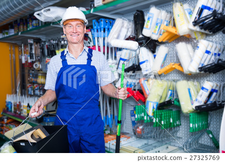 smiling workman in hardhat buying painting roller smiling workman in hardhat buying painting roller 27325769