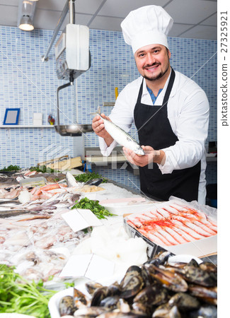 Man in cap showing fish Man in cap showing fish 27325921