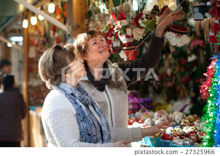 female pensioners buying X-mas decorations at fair 27325966