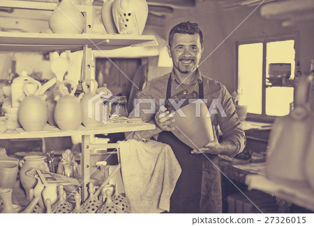 Male artisan in ceramic workshop. 27326015